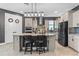 Modern kitchen with granite countertops, stainless steel appliances, a center island with seating, and a stylish backsplash at 2330 Nuthatch St, St Cloud, FL 34771
