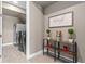 Stylish laundry room with stainless steel washer and dryer and decorative shelving and decor at 2330 Nuthatch St, St Cloud, FL 34771