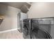 Laundry room featuring stainless steel washer and dryer and decorative shelving and decor at 2330 Nuthatch St, St Cloud, FL 34771