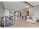Bright living room featuring wood-look tile floors, fireplace, and access to other rooms at 2330 Nuthatch St, St Cloud, FL 34771