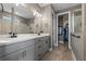 Well-lit bathroom featuring dual sinks, a walk-in shower, private toilet and access to a walk-in closet at 2330 Nuthatch St, St Cloud, FL 34771