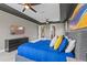 Bright main bedroom featuring a tray ceiling, en suite access, television and modern decor at 2330 Nuthatch St, St Cloud, FL 34771