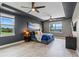 Large main bedroom with tray ceiling, three windows, and stylish decor at 2330 Nuthatch St, St Cloud, FL 34771