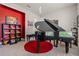 Music room with grand piano and colorful accent wall at 2330 Nuthatch St, St Cloud, FL 34771