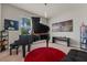 Music room showcasing grand piano, decorative lighting, and modern artwork at 2330 Nuthatch St, St Cloud, FL 34771