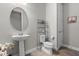 Clean and modern powder room features pedestal sink and space-saving storage at 2330 Nuthatch St, St Cloud, FL 34771