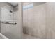 Clean shower featuring glass door, tile surround, shower niche and a rainfall showerhead at 2330 Nuthatch St, St Cloud, FL 34771