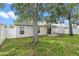Backyard view featuring partial grass, a patio, and a large shade tree at 2336 Martins Run, Tavares, FL 32778