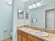 Bathroom featuring dual sinks with a large framed mirror and blue walls at 2336 Martins Run, Tavares, FL 32778