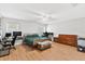 Spacious bedroom with wood-look floors, ceiling fan, and natural light at 2336 Martins Run, Tavares, FL 32778