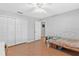 Neutral bedroom featuring wood floors, a ceiling fan, and a spacious closet at 2336 Martins Run, Tavares, FL 32778
