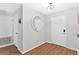 Bright entryway features wood floors, a round mirror and neutral wall paint at 2336 Martins Run, Tavares, FL 32778