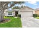 Charming single-story home with a well-maintained lawn and mature tree at 2336 Martins Run, Tavares, FL 32778