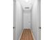 Hallway with hardwood floors and white doors at 2336 Martins Run, Tavares, FL 32778