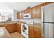 Traditional kitchen featuring wood cabinets, modern appliances, and laminate countertops at 2336 Martins Run, Tavares, FL 32778