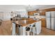 Open kitchen featuring wooden cabinets, stainless appliances, and a center island at 2336 Martins Run, Tavares, FL 32778