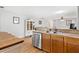 Kitchen features wood cabinets, stainless dishwasher with view of dining room at 2336 Martins Run, Tavares, FL 32778