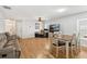 Open living area with wood floors, comfortable seating, and dining space at 2336 Martins Run, Tavares, FL 32778