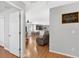 View of the dining and living room boasting wood floors and a Gathering art piece at 2336 Martins Run, Tavares, FL 32778
