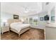 Bright bedroom with tray ceilings, wood floors, and a large window at 2585 Constance Ct, The Villages, FL 32163