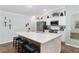 Bright kitchen with stainless steel appliances, white cabinets and a large island at 2585 Constance Ct, The Villages, FL 32163