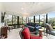 Bright sunroom with tile floors, floor to ceiling windows and a ceiling fan at 2585 Constance Ct, The Villages, FL 32163