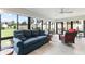 Sunroom with lots of natural light, tile floors and a view of the backyard at 2585 Constance Ct, The Villages, FL 32163