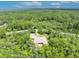 Scenic aerial perspective of a dwelling embraced by the verdant canopy of a mature forest at 30342 Vitex Ave, Eustis, FL 32736