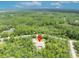 Prime aerial shot highlights property location within a serene, wooded, and private environment at 30342 Vitex Ave, Eustis, FL 32736