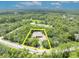 Aerial view of property lines around a secluded home enveloped by a dense forest at 30342 Vitex Ave, Eustis, FL 32736