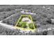 Aerial view of the property boundary in yellow in a verdant, wooded setting at 30342 Vitex Ave, Eustis, FL 32736