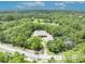 Expansive aerial view of home nestled within a dense green forest at 30342 Vitex Ave, Eustis, FL 32736