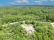 Overview of home surrounded by dense trees, a secluded escape for ultimate privacy at 30342 Vitex Ave, Eustis, FL 32736