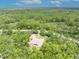Overhead of the home with surrounding trees, a hidden gem providing tranquility and seclusion at 30342 Vitex Ave, Eustis, FL 32736