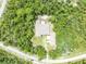 Bird's-eye view showcases the home's unique roof layout and surrounding manicured lawn at 30342 Vitex Ave, Eustis, FL 32736