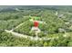 Aerial view with locator pin of a secluded residence nestled in a lush, forested landscape at 30342 Vitex Ave, Eustis, FL 32736