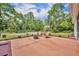 Backyard patio area with a cozy fire pit, chairs and peaceful wooded backdrop at 30342 Vitex Ave, Eustis, FL 32736