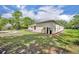 Expansive backyard with lush grass, patio, mature trees, and a serene setting at 30342 Vitex Ave, Eustis, FL 32736