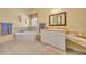 Relaxing bathroom with soaking tub, double sinks, and vanity area at 30342 Vitex Ave, Eustis, FL 32736