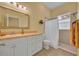 Bright, well-lit bathroom featuring a shower, toilet and vanity at 30342 Vitex Ave, Eustis, FL 32736