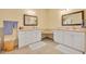 Bathroom featuring double sinks, white cabinets, and light countertops at 30342 Vitex Ave, Eustis, FL 32736