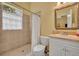 Well-lit bathroom featuring shower, toilet, vanity and medicine cabinet at 30342 Vitex Ave, Eustis, FL 32736