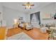 Sunlit bedroom with wood floors, soft decor and large window at 30342 Vitex Ave, Eustis, FL 32736