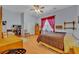 Cozy bedroom featuring natural light, neutral colors, wood floors and ceiling fan at 30342 Vitex Ave, Eustis, FL 32736