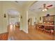Dining and Living areas featuring hardwood floors, arches, ceiling fan, and natural light at 30342 Vitex Ave, Eustis, FL 32736