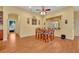 Open dining area with hardwood floors, wooden table and chairs, and natural light at 30342 Vitex Ave, Eustis, FL 32736