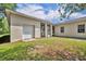 Exterior view of house with screened in patio, garage and grassy area at 30342 Vitex Ave, Eustis, FL 32736