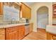 Kitchen area showcases stainless steel dishwasher, sink, and wooden cabinets at 30342 Vitex Ave, Eustis, FL 32736