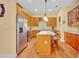 Well-equipped kitchen with stainless steel appliances, an island, and wood cabinets at 30342 Vitex Ave, Eustis, FL 32736