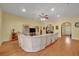 Spacious living room featuring hardwood floors, yellow walls, and a huge comfortable sectional couch at 30342 Vitex Ave, Eustis, FL 32736